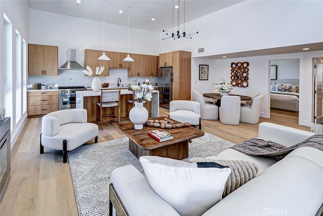 2304 Grant Ave Unit A, Redondo Beach, CA 90278 - living room with a towering ceiling, light wood-type flooring, and recessed lighting