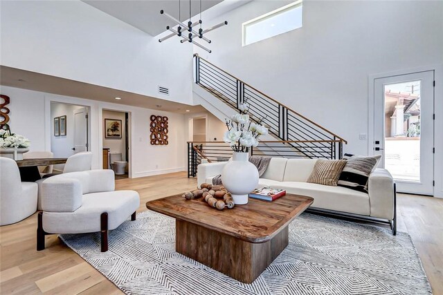 2304 Grant Ave Unit A, Redondo Beach, CA 90278 - living area featuring light wood-style floors, stairs, a high ceiling, and a chandelier