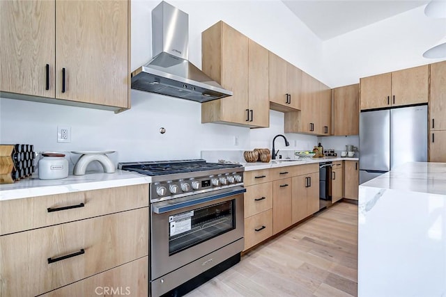 2304 Grant Ave Unit A, Redondo Beach, CA 90278 - kitchen with wall chimney exhaust hood, stainless steel appliances, light brown cabinetry, a sink, and light wood-style floors