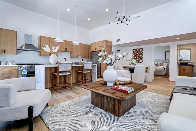 2304 Grant Ave Unit A, Redondo Beach, CA 90278 - living area with a towering ceiling, light wood-style floors, a chandelier, and recessed lighting