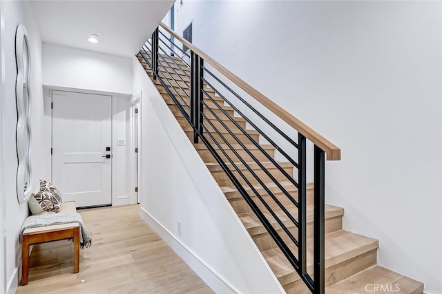 staircase with hardwood / wood-style flooring