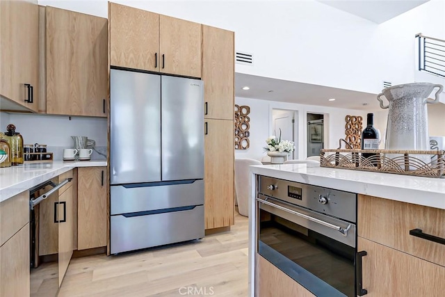 2304 Grant Ave Unit A, Redondo Beach, CA 90278 - kitchen with appliances with stainless steel finishes, light wood-style floors, light brown cabinetry, recessed lighting, and light stone counters