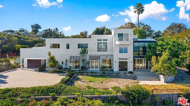 modern home with a balcony and a garage