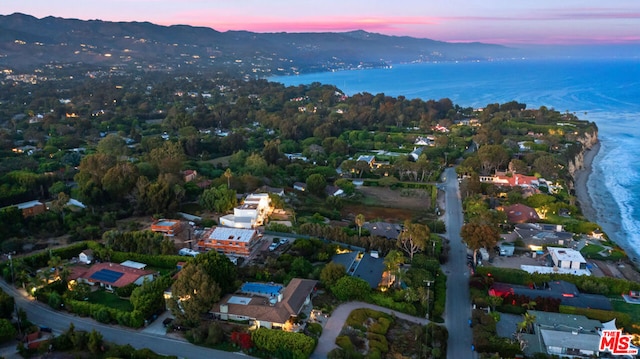 aerial view at dusk with a water and mountain view