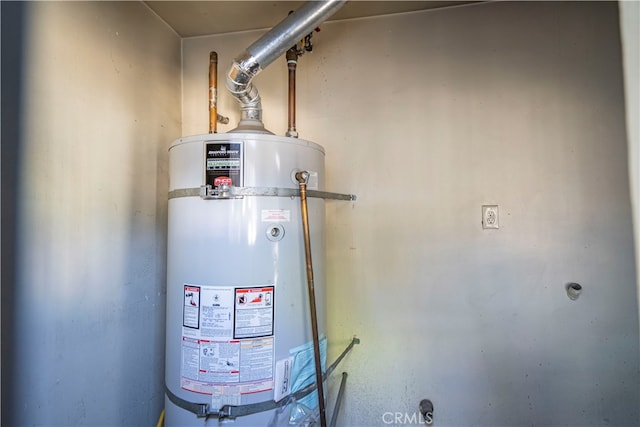 utility room featuring strapped water heater