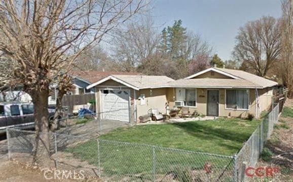 ranch-style home with a front yard and a garage