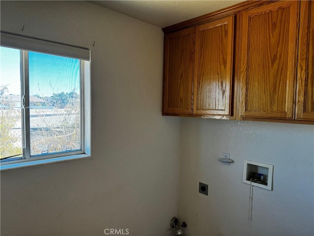 washroom with cabinets, washer hookup, and hookup for an electric dryer