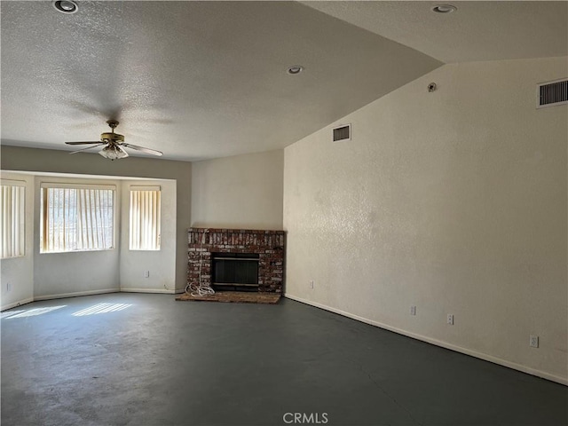 unfurnished living room with a textured ceiling, ceiling fan, lofted ceiling, and a fireplace