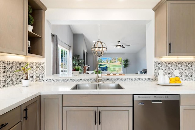 kitchen with stainless steel dishwasher, light brown cabinetry, sink, and decorative backsplash