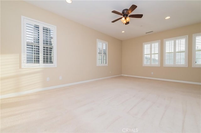 carpeted spare room with ceiling fan