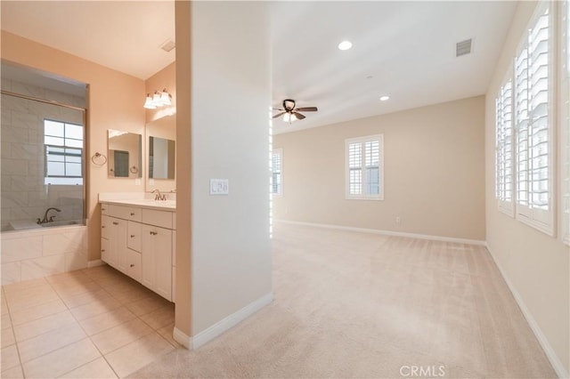 bathroom with ceiling fan, vanity, plus walk in shower, and tile patterned floors