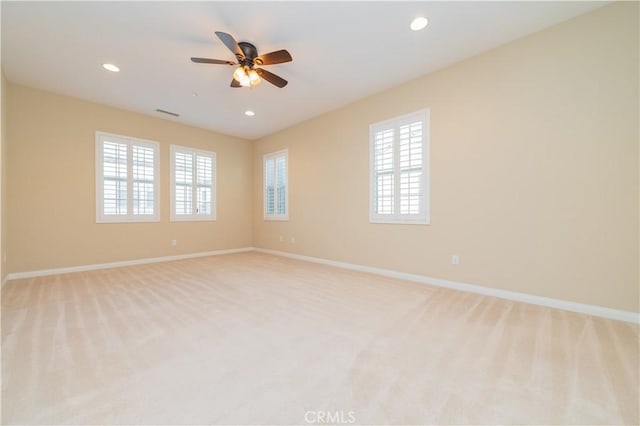 carpeted spare room with ceiling fan