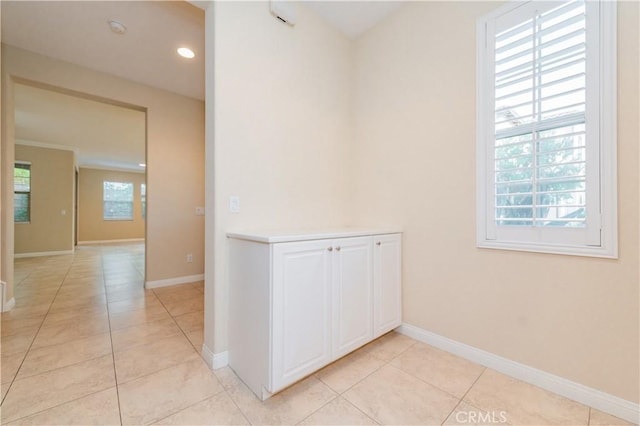 corridor with plenty of natural light and light tile patterned floors