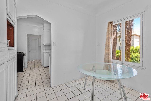 kitchen featuring white cabinets, light tile patterned flooring, and tasteful backsplash