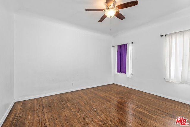 empty room with ceiling fan and hardwood / wood-style flooring