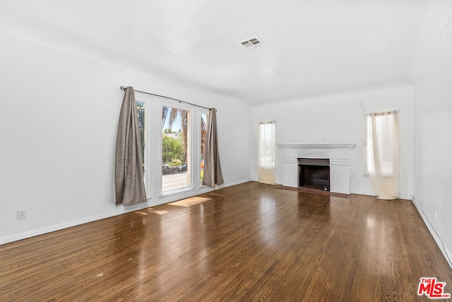 unfurnished living room with dark hardwood / wood-style floors