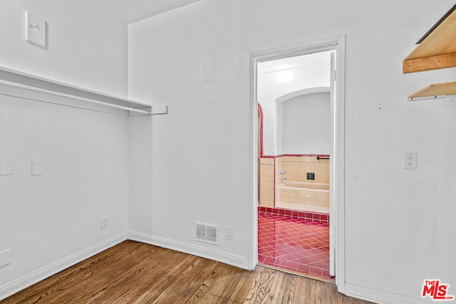 walk in closet featuring hardwood / wood-style flooring