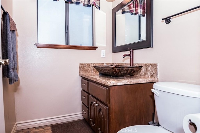 bathroom featuring hardwood / wood-style flooring, vanity, and toilet