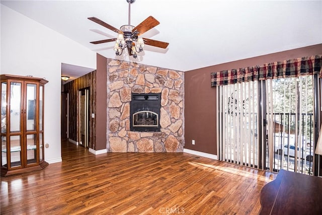 unfurnished living room featuring a fireplace, hardwood / wood-style flooring, high vaulted ceiling, and ceiling fan