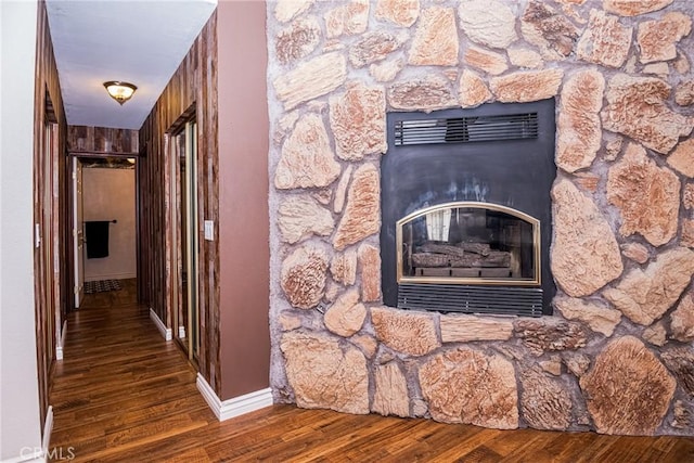 interior details with a stone fireplace and hardwood / wood-style floors