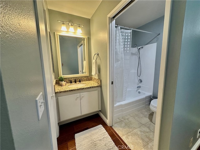 full bathroom with shower / bath combo with shower curtain, tile patterned floors, vanity, and toilet