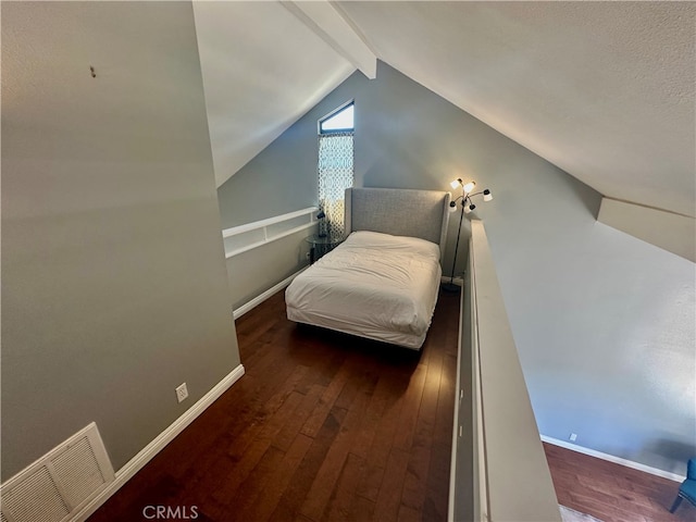 bedroom with vaulted ceiling with beams and dark wood-type flooring