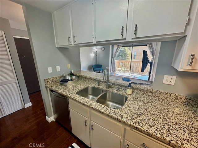 kitchen with white cabinetry, dark wood-type flooring, light stone countertops, dishwasher, and sink