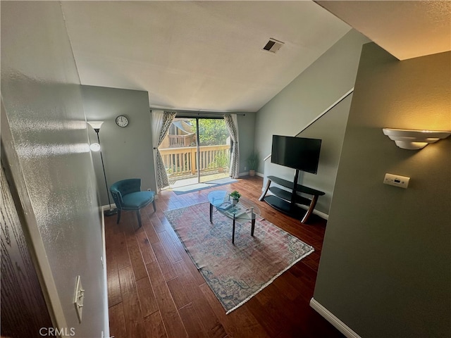 living room with vaulted ceiling and hardwood / wood-style floors