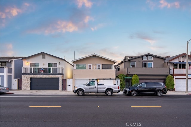 view of front of home featuring a balcony and a garage