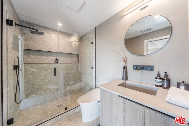 bathroom with tile patterned flooring, vanity, toilet, and a shower with shower door