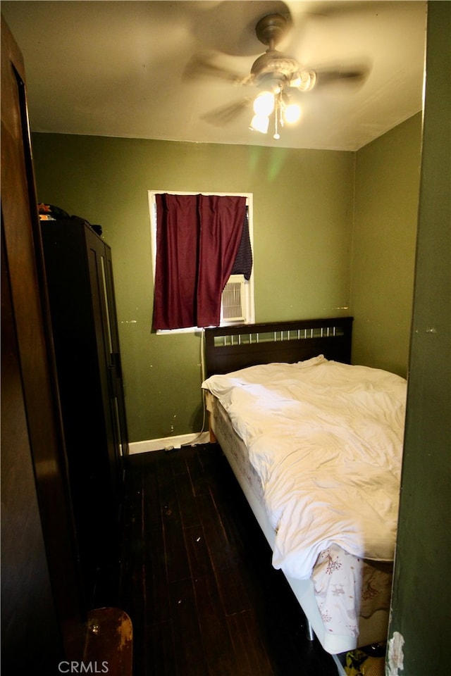 bedroom with ceiling fan and dark hardwood / wood-style flooring