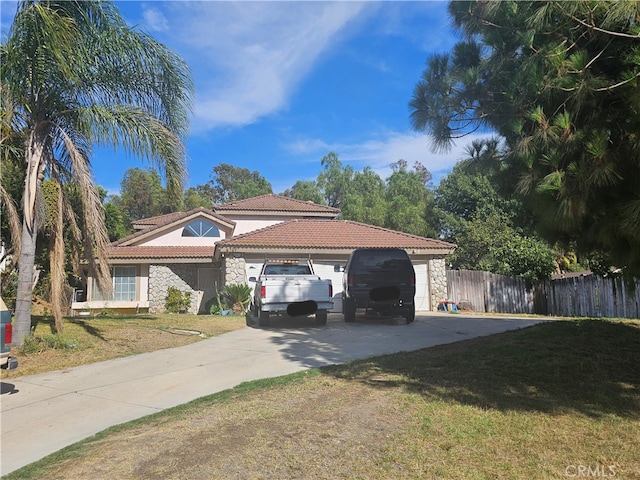 mediterranean / spanish house with a garage and a front lawn