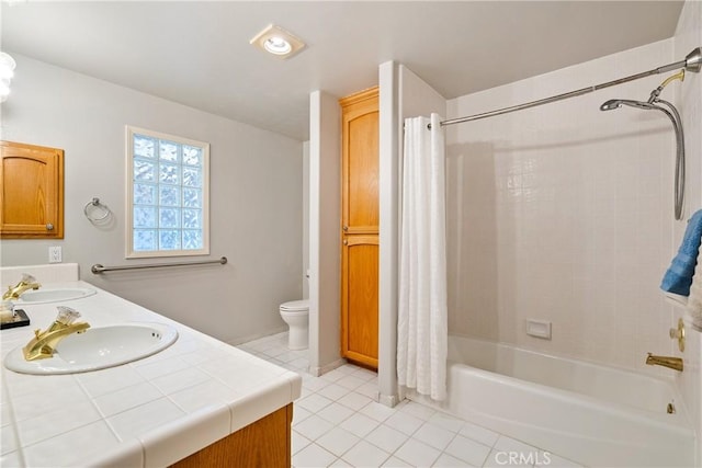 full bathroom with tile patterned flooring, vanity, shower / bath combo with shower curtain, and toilet