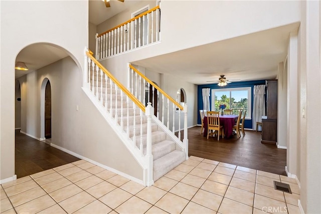 entrance foyer with ceiling fan and light tile patterned flooring