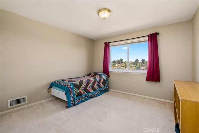 bedroom with light colored carpet