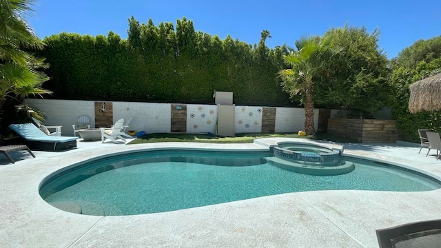 view of pool with an in ground hot tub and a patio