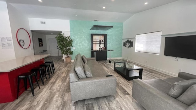 living room with lofted ceiling and wood-type flooring