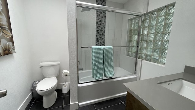 full bathroom with toilet, bath / shower combo with glass door, vanity, and tile patterned flooring