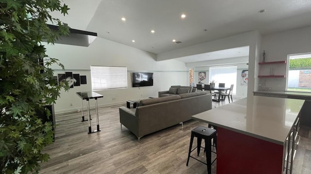 living room featuring hardwood / wood-style floors and vaulted ceiling