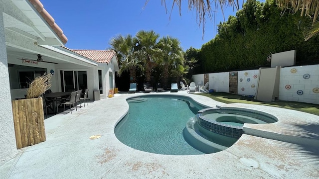 view of swimming pool with a patio and an in ground hot tub