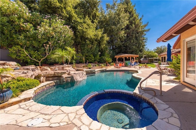 view of pool featuring an in ground hot tub, a gazebo, and a patio