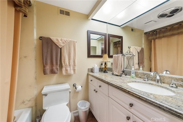 full bathroom featuring toilet, vanity, and shower / tub combo with curtain