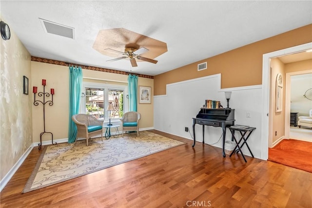 living area featuring ceiling fan and hardwood / wood-style floors