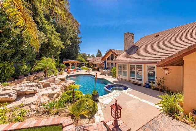 view of pool featuring a gazebo, a patio area, and an in ground hot tub