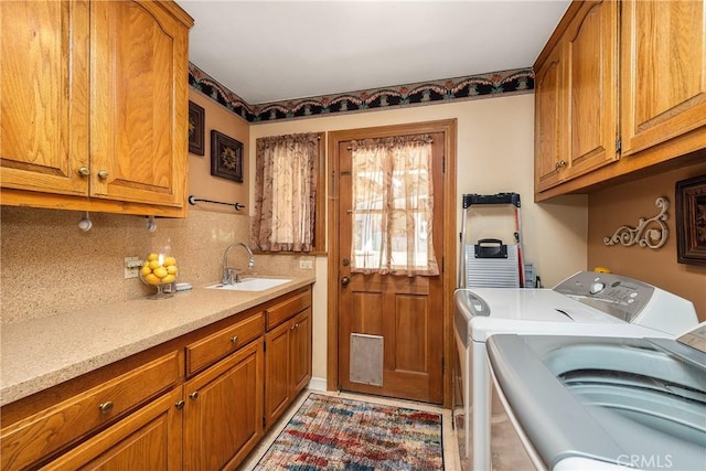 laundry room featuring cabinets, sink, and washer and dryer