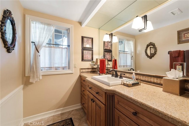 bathroom with vanity, tile patterned floors, and a wealth of natural light