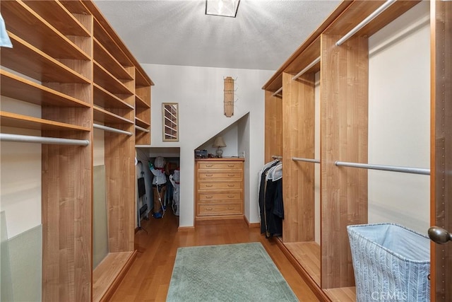 spacious closet featuring light hardwood / wood-style floors