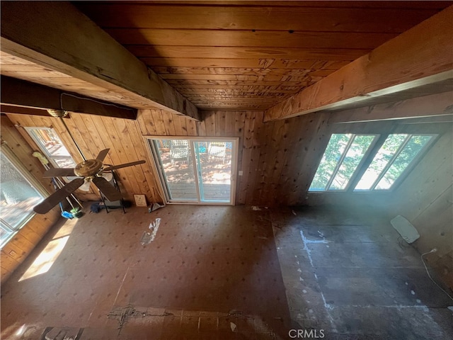 misc room with ceiling fan and wood walls