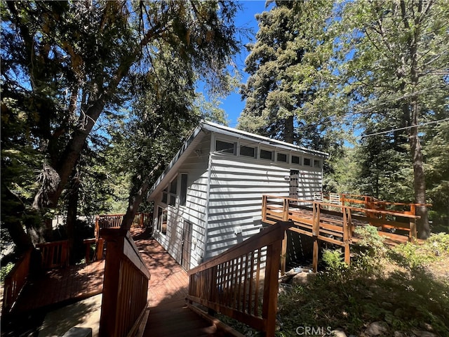 view of home's exterior featuring a wooden deck