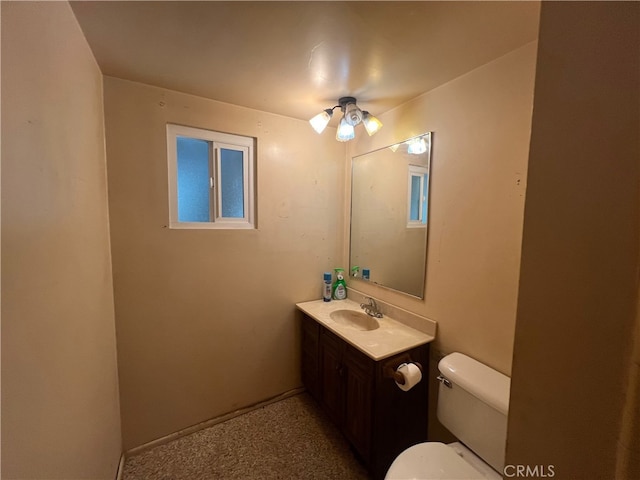 bathroom with vanity, toilet, and ceiling fan